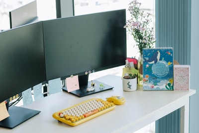 White black tablet computer monitors on the desktop
